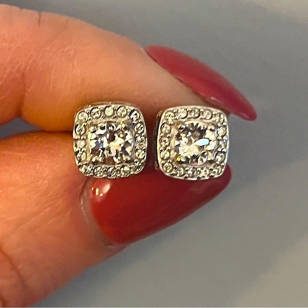 Sterling silver cubic zirconia halo stud earrings.